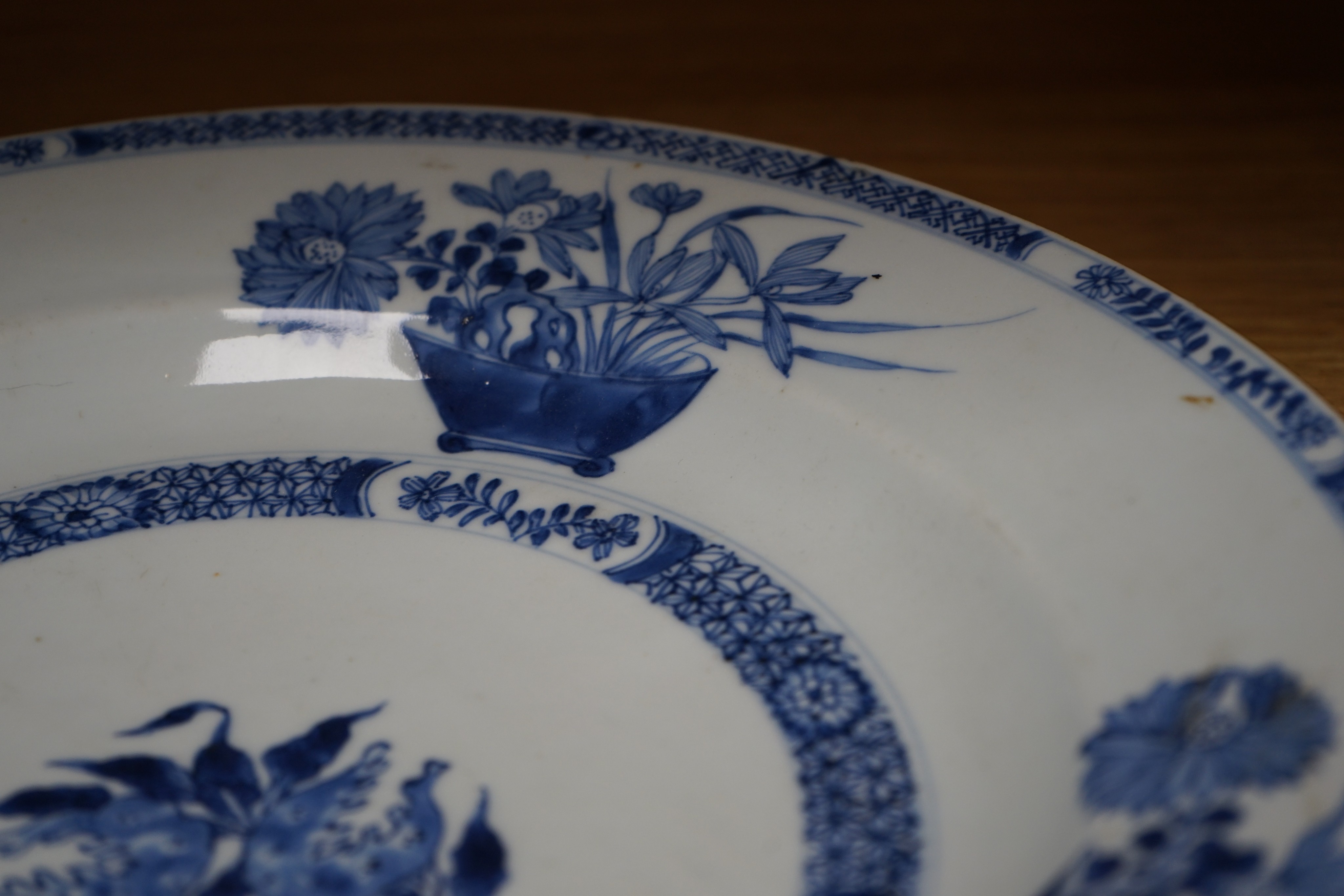 An 18th century Chinese blue and white circular dish decorated with flowering plants, Dia 32.5cm